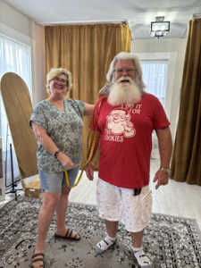 Santa standing with his helpful helper