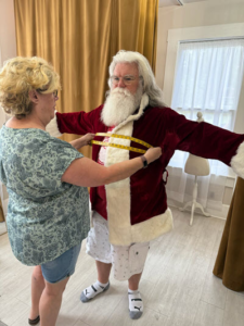 Santa being measured in the jacket
