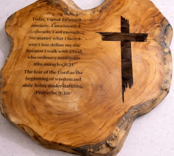 Woodwork cross with proverbs on a board