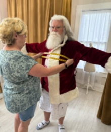 Santa being measured in the jacket